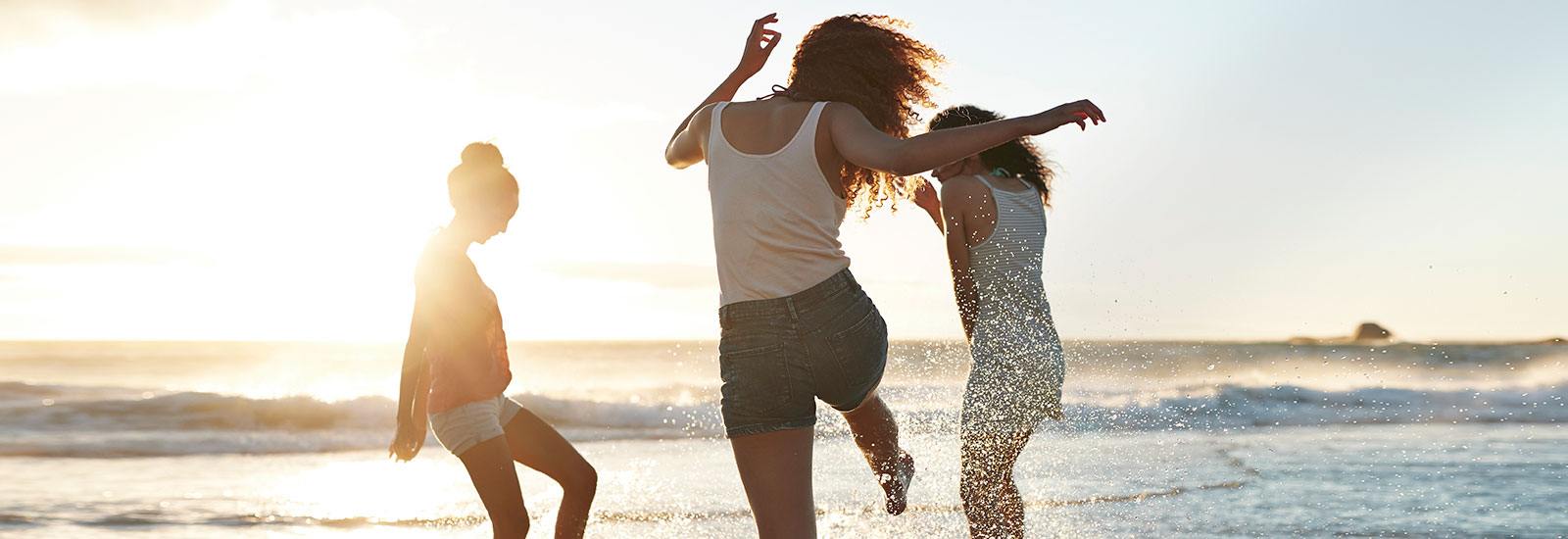 Women dancing on the beach.
