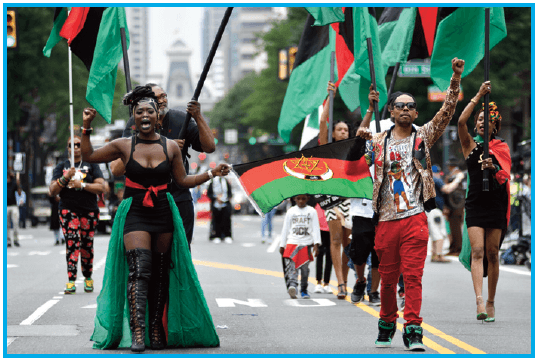 Photo of people walking in a Juneteenth parade.