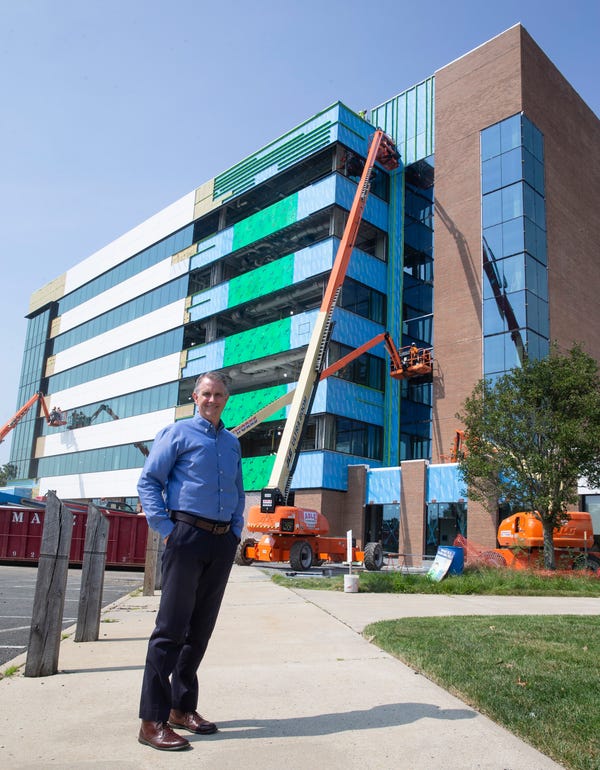 Chris Maher standing in front of new HQ1 Building
