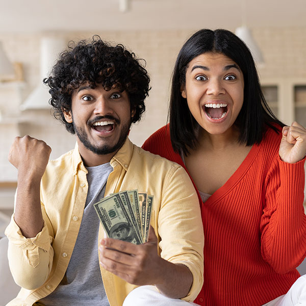 Couple Smiling Holding Money