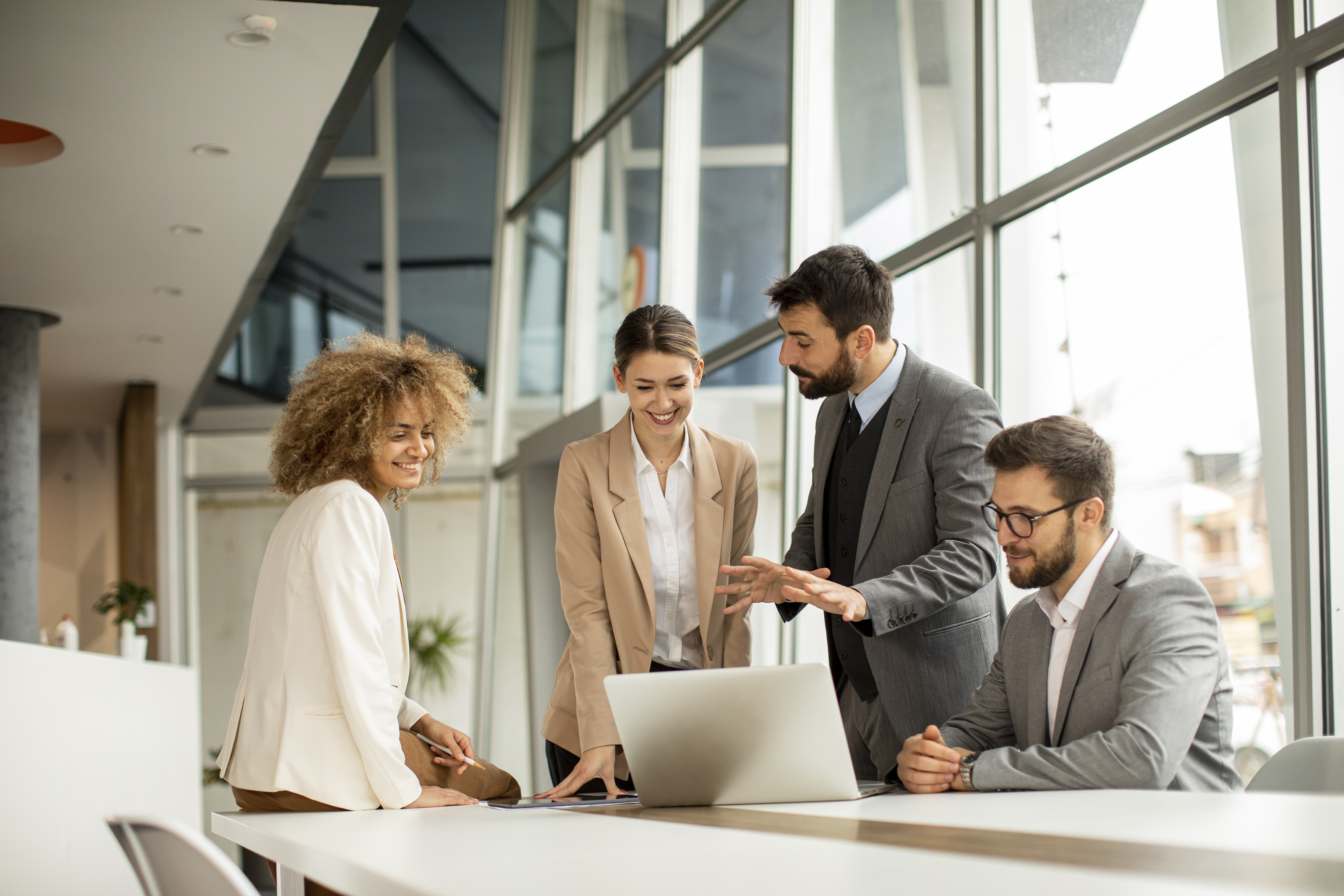 A group of people talking at a desk